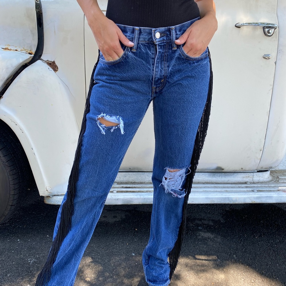 Vintage distressed Levi’s with black beaded hanging side legs